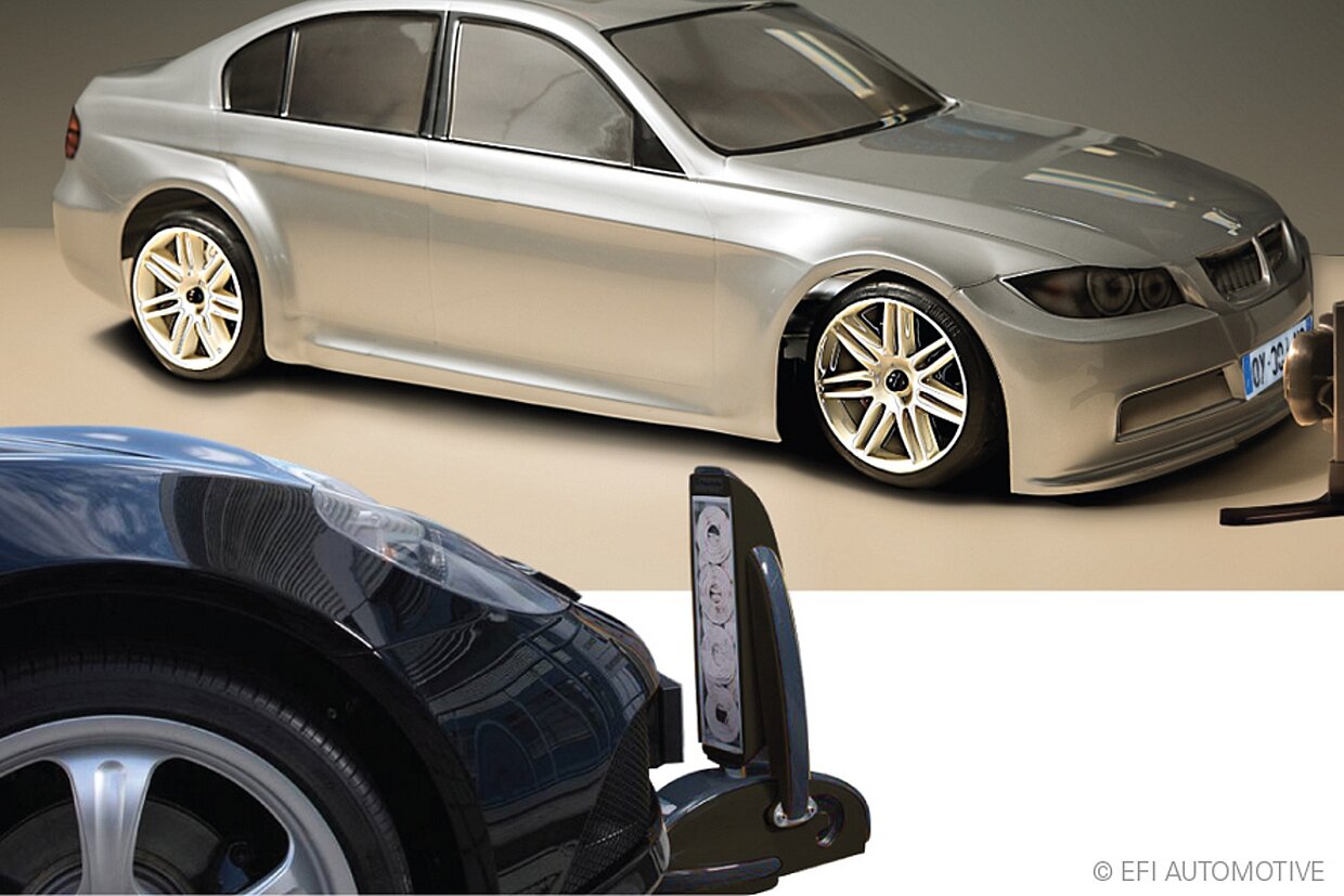 Induktionsladesystem für E-Fahrzeuge Demonstration eines Induktionsladesystems an einem silbernen und einem schwarzen Auto